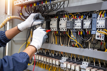Electricity and electrical maintenance service, Engineer hand holding AC voltmeter checking...