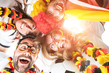 Group of enthusiastic German soccer fans celebrating the victory