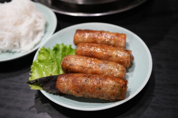 Deep fried Spring Rolls with green vegetable on banana leaf and white plate - 春巻き

