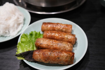 Deep fried Spring Rolls with green vegetable on banana leaf and white plate - アジア料理 春巻き
