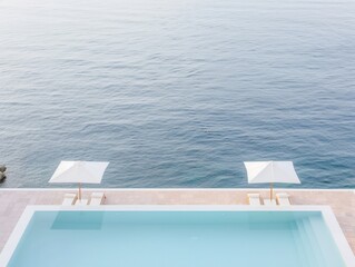 Obraz premium Luxurious Seaside Swimming Pool with Sun Loungers and Umbrellas Overlooking Infinite Ocean Views for a Relaxing Vacation