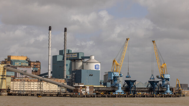 Tate and Lyle Factory on the River Thames in London, England, UK, historic industrial sugar refinery and riverside manufacturing landmark along the Thames waterfront.