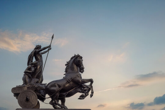London Boadicea statue near Westminster and Big Ben with historic bronze sculpture and evening sky in England.