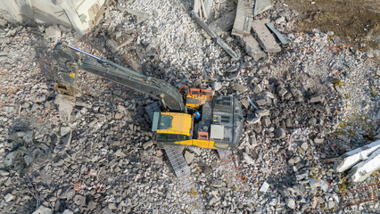 Drone photography pf machinery demolishing a building during spring day