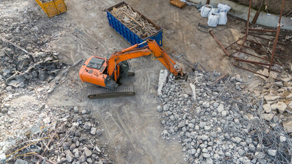 Drone photography pf machinery demolishing a building during spring day