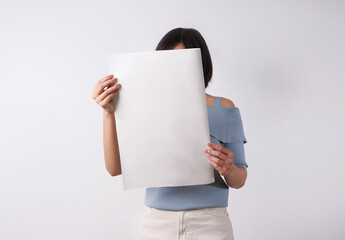 Woman reading mockup of blank newspapers to add your own news isolated on white background.