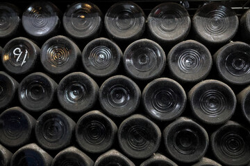 Background concept - bases of old wine bottles, stacked in cellar, near town of Toodyay, Wheatbelt region, Western Australia