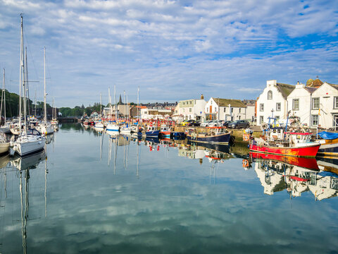 The harbour at Eyemouth in the Borders Region of Scotland on a Spring morning, with working and leisure boats moored at the quays.