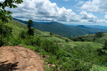 A woman hiker treks a mountain trail in the summer Caucasus, enjoying the scenic landscape