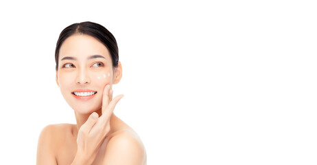 Young woman with glowing skin smiles as she applies skincare cream, highlighting the benefits of a consistent beauty regimen. Her radiant complexion and joyful expression convey health and confidence.