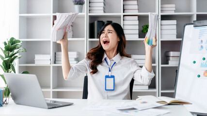 A woman is holding a stack of papers and yelling in excitement