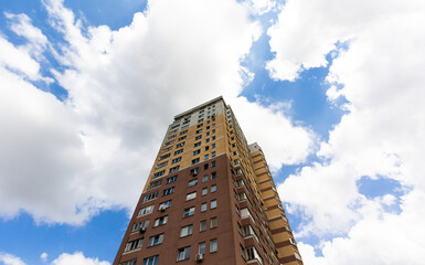 Fototapeta premium Modern residential building on a sunny day. Residential building with blue sky. Facade of a modern residential building.