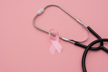 Breast Cancer Awareness pastel pink Background with Pink Ribbon and Stethoscope