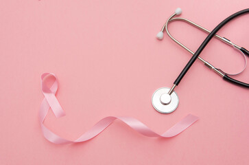 Pink large Ribbon and Stethoscope on pink background with copy space, Breast Cancer Awareness