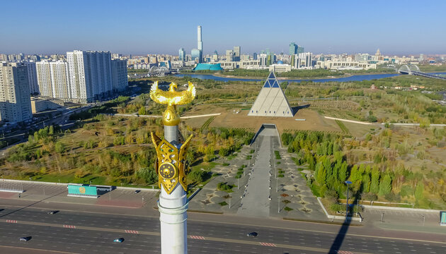 The top of Kazakh Eli monument with Palace of Peace and Reconciliation in Astana, the capital of Kazakhstan, with Presidential Park around, the Ishim river, the Presidential palace (Ak Orda), Abu-Dhab