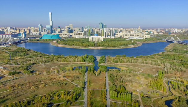 The aerial view of Presidential park in Astana and Presidential Palace (Ak Orda) in Kazakhstan, Central Asia, with Ishim River, bridges, Abu-Dhabi Plaza, and city downtown panorama in the background.

