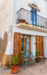 Facade of a typical Mediterranean house with its white style and blue windows.
