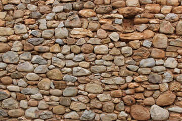 Stone wall in an old abandoned and ruined house