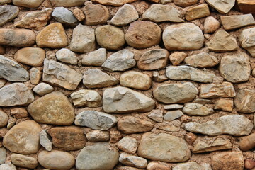 Stone wall in an old abandoned and ruined house