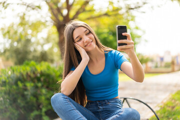 Teenager girl at outdoors using mobile phone