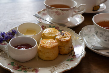 Close up of Scones Strawberry Jam and Butter Served with Hot Tea in Afterernoon