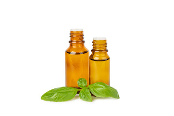 Basil essential oil isolated on white background. Basil essential oil and fresh leaves. Aromatherapy. Aroma oil. Medical herbs. Alternative medicine. Place for text. Copy space.
