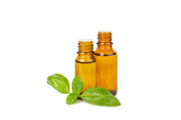 Basil essential oil isolated on white background. Basil essential oil and fresh leaves. Aromatherapy. Aroma oil. Medical herbs. Alternative medicine. Place for text. Copy space.
