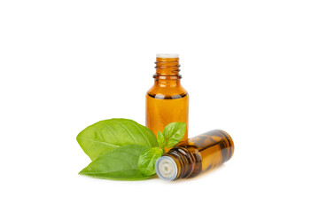 Basil essential oil isolated on white background. Basil essential oil and fresh leaves. Aromatherapy. Aroma oil. Medical herbs. Alternative medicine. Place for text. Copy space.
