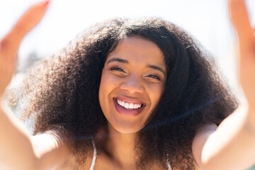 Young African American woman at outdoors With happy expression