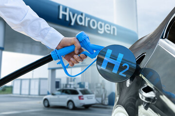 Man holds a hydrogen fueling nozzle. Refueling car with hydrogen fuel. Concept