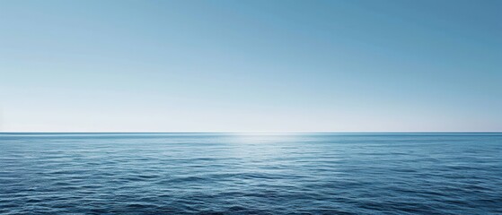 Obraz premium The ocean is calm and peaceful, with a clear blue sky above