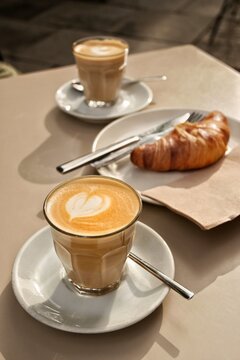 Desayuno o merienda compuesta de caf&eacute; con leche con forma de coraz&oacute;n y croissant