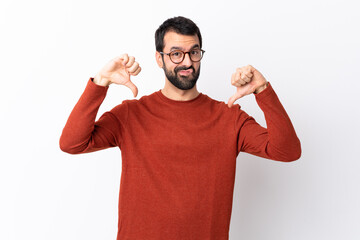 Caucasian handsome man with beard over isolated white background showing thumb down