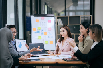 Professional team at and both male and female members participated in a lively brainstorming session at the company office. They collaborate on creative projects using modern technology.