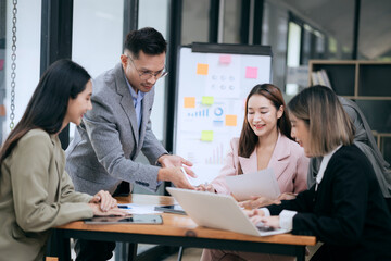 Professional team at and both male and female members participated in a lively brainstorming session at the company office. They collaborate on creative projects using modern technology.