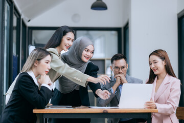 Professional team at and both male and female members participated in a lively brainstorming session at the company office. They collaborate on creative projects using modern technology.