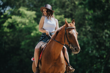 Woman riding a horse outdoors in a green forest setting. She is wearing a hat and appears relaxed and content.