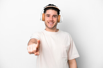 Young caucasian man isolated on white background listening music