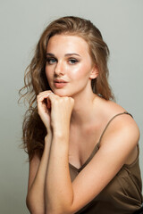 Naklejka premium Attractive smiling young adult woman studio photo