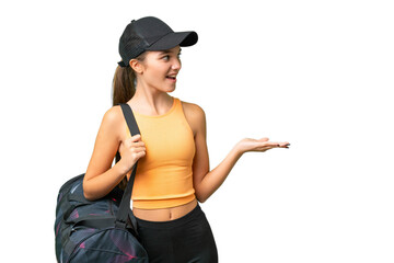 Teenager caucasian girl with sport bag over isolated background with surprise facial expression