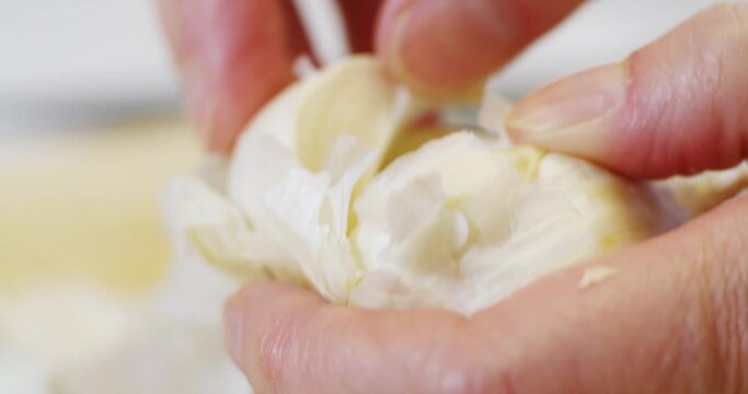 Peeling skin from garlic clove