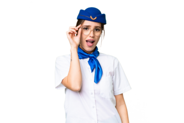 Airplane stewardess over isolated chroma key background with glasses and surprised