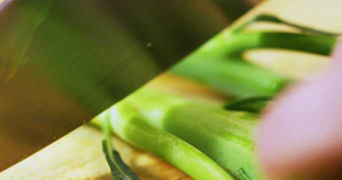 Chopping broccolini into pieces