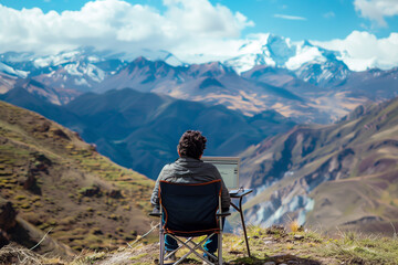 digital nomad taking a break from work to enjoy a scenic mountain view. The setting includes a portable laptop on a small table, a comfortable chair, and a breathtaking landscape i