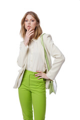 High fashion photo of a beautiful elegant young woman in pretty green pants, trousers, jacket,  handbag posing on white background. Slim figure. Blonde