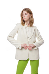 High fashion photo of a beautiful elegant young woman in pretty green pants, trousers, jacket posing on white background. Slim figure. Blonde