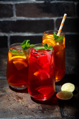 assortment of refreshing cold black and fruit tea, vertical