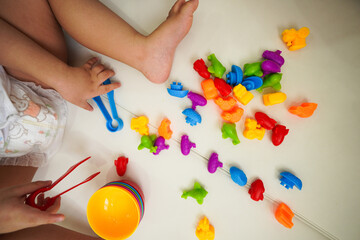 Baby sitting and playing colorful vehicle toy