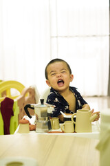 Cute asian young boy smiling with mokapot and demo of pot