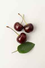Cherry with leaves on a white background